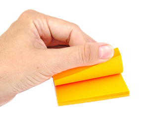 Hand with a block of yellow post it notes or notepapers on a