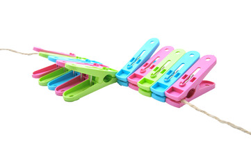 clothes-pegs isolated on a white background. Slightly defocused and close-up shot.