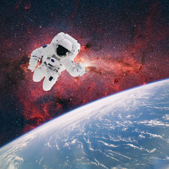 Astronaut in outer space with planet earth as backdrop. Elements © ibreakstock