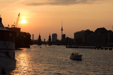 Berlin skyline sunset over kreuzberg , tv tower, spree, oberbaum bridge