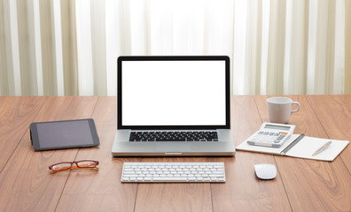 Blank screen laptop computer on wooden table