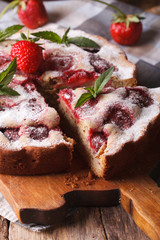 strawberry pie with mint on a cutting board macro. Vertical
