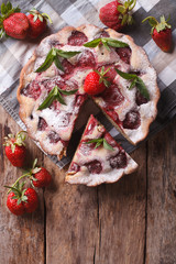 sliced pie with fresh strawberries a close-up vertical top view
