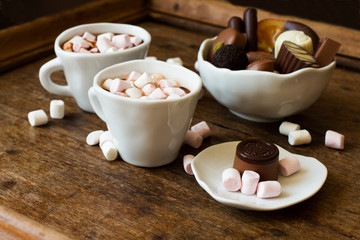 Belgian chocolate in a white bowl on a wooden table