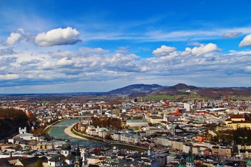Salzburg city in birds eyes view / Salzburg city along Salzach river under blue sky
