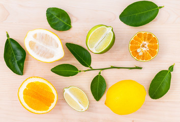 Mixed citruses fruit oranges, lemon and lime on wooden backgroun