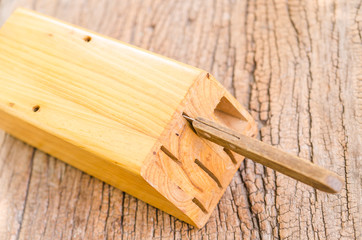 wooden knife block on wooden background