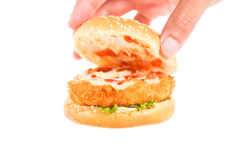 Hand holds big hamburger on white background