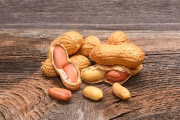 Peanuts in shells on wooden background