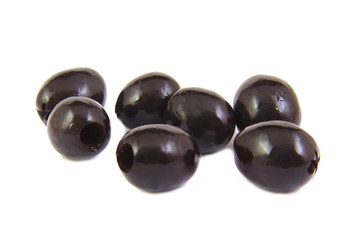 Close up of black sweet olives on a white background