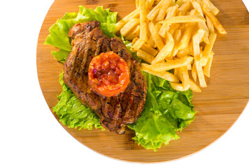 Grilled steak, french fries and lettuce
