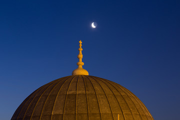 Fototapeta na wymiar Suleymaniye Mosque dome in Istanbul and a new moon in the night sky