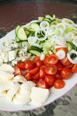 Big oval plate with various vegetable and cheeses