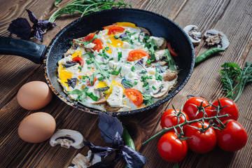 Eggs with vegetabls on rustic wooden background