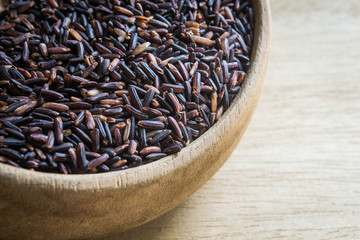 Black rice in wooden bowl