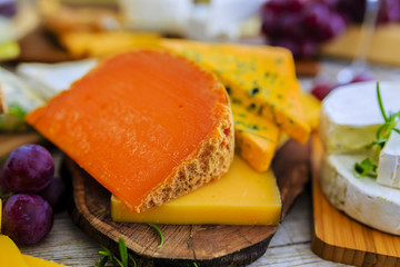 Cheese - different types of cheese on a wooden table