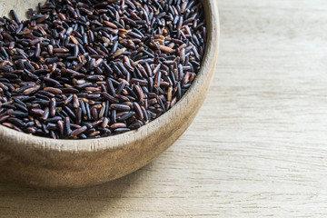 Black rice in wooden bowl