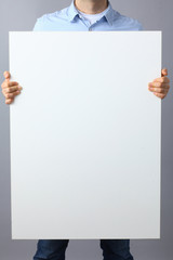 Businessman holding a blank  board