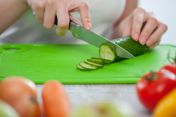 Young woman is preparing healthy tasty salad