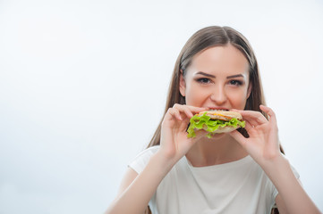 Beautiful young girl is eating unhealthy food