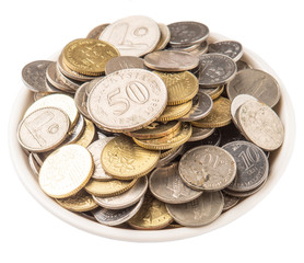 Malaysian coins in a white bowl over white background