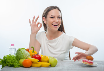Pretty young girl is refusing to eat unhealthy food