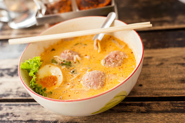 Pork noodle tom yum on wood table