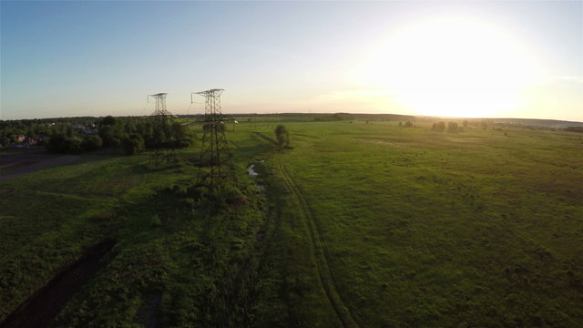 Flying over power line at sunset, aerial survey