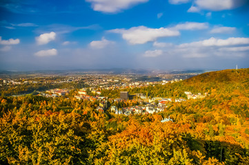 Top view on forest and Carlovy Vary at autumn