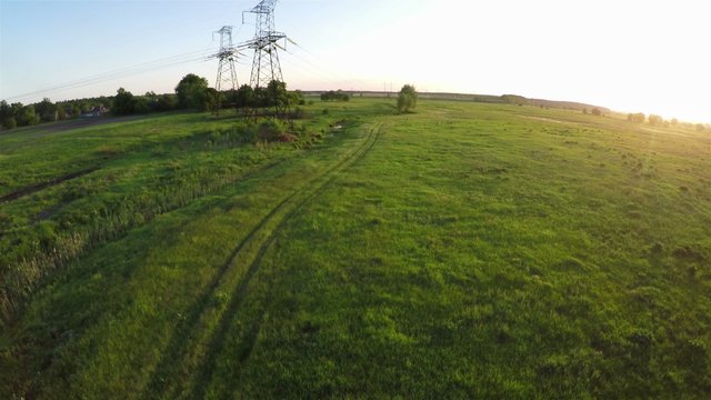 Flying over power line at sunset, aerial survey