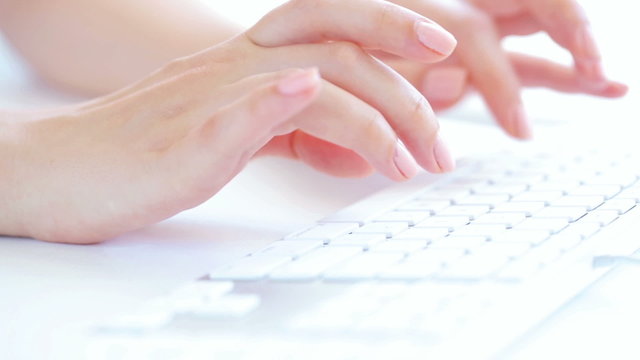 Womans hands typing on the keyboard