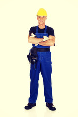 Full length mature worker with folded arms