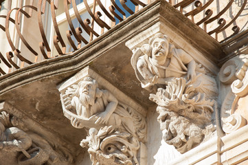 View of some typical baroque mascarons under the balconies of Cosentini Palace in Ragusa Ibla, Sicily - obrazy, fototapety, plakaty