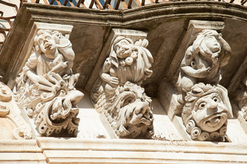 View of some typical baroque mascarons under the balconies of Cosentini Palace in Ragusa Ibla, Sicily