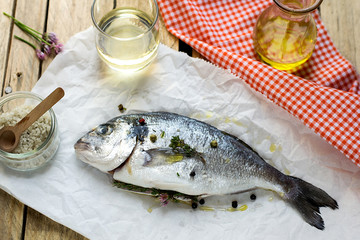 Fresh fish gilt-head bream dorade with salt and pepper