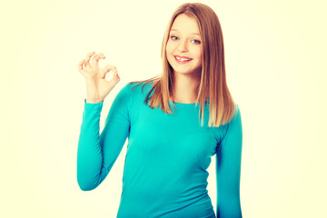 Young woman showing perfect sign