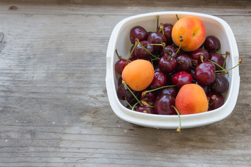 apricots and cherries on wood table