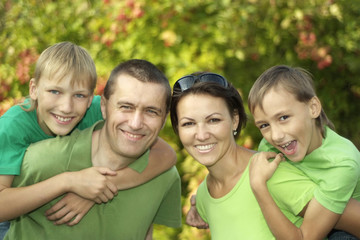 friendly family in green shirts 