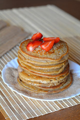 Stack of sweet pancakes with strawberries and cinnamon sugar 