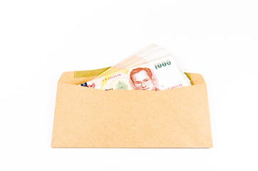 Stack of thai banknote on brown envelope  isolated on white back