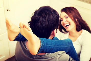 Romantic couple hugging in the kitchen.