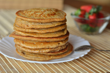 Stack of sweet pancakes with strawberries and cinnamon 
