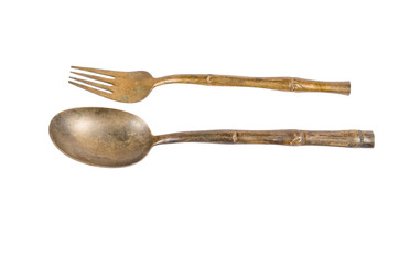 old brass spoon and fork isolated on white background