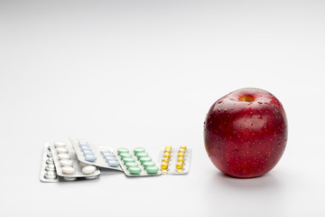 Red apple and pills blister