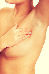 Fototapeta premium Nude woman examining her breast