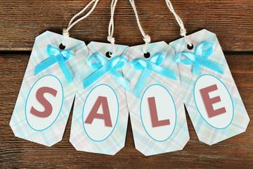 Sale tags on wooden background