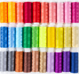 Background from bobbins with multicolored thread