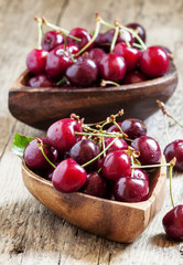 Fresh  cherries in a wooden bowl in the shape of a heart, select