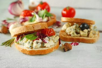 Tasty sandwiches on wooden table, close up