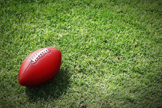 Rugby Ball On Green Field